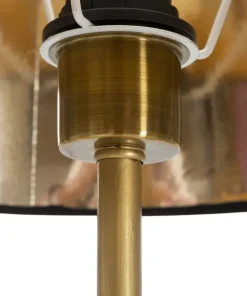 Lampe de sol dorée avec abat-jour en tissu noir et décor perroquets